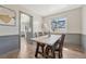 Dining room with wood-look flooring and view to kitchen at 7541 Julian St, Westminster, CO 80030