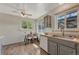 Eat-in kitchen with gray cabinets, ceiling fan, and wood-look flooring at 7541 Julian St, Westminster, CO 80030