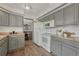 This updated kitchen features grey cabinets, wood countertops and updated appliances at 7541 Julian St, Westminster, CO 80030