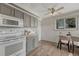Functional kitchen with white appliances, gray cabinets, ceiling fan, and wood-look floors at 7541 Julian St, Westminster, CO 80030