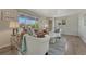 Inviting living room features stylish furnishings, hardwood floors, with great natural light, and an inviting couch at 7541 Julian St, Westminster, CO 80030