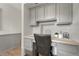Small office space with desk, cabinets, and wood-look flooring at 7541 Julian St, Westminster, CO 80030