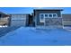 Modern two-story home with gray and white exterior, two-car garage, and snowy front yard at 24720 E 36Th Ave, Aurora, CO 80019