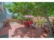 Deck featuring patio furniture and a red umbrella shaded by mature trees, perfect for outdoor relaxation at 6085 S Parfet St, Littleton, CO 80127