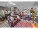 Open living room with comfortable seating, a striking rug, and lots of natural light at 6085 S Parfet St, Littleton, CO 80127