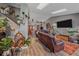 Spacious living room featuring a vaulted ceiling, skylights, modern furnishings, and stylish decor at 6085 S Parfet St, Littleton, CO 80127