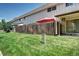 A fenced backyard with green grass provides privacy and ample space for outdoor activities at 4856 E Hinsdale Pl, Centennial, CO 80122