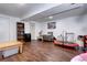 Spacious finished basement with wood flooring, a cozy sitting area, and plenty of room for activities at 4856 E Hinsdale Pl, Centennial, CO 80122