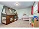 Fun bedroom with a unique log cabin bunk bed, a crib, and playful decor at 4856 E Hinsdale Pl, Centennial, CO 80122