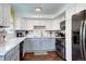 Charming kitchen featuring white and gray cabinets, marble countertops, and stainless steel appliances at 4856 E Hinsdale Pl, Centennial, CO 80122