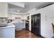 Modern kitchen featuring white cabinets, stainless steel appliances, and stylish gray countertops at 4856 E Hinsdale Pl, Centennial, CO 80122