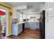 Well-lit kitchen featuring white cabinets, gray countertops, stainless steel appliances, and hardwood floors at 4856 E Hinsdale Pl, Centennial, CO 80122