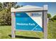Medema Park signage on a sunny day, surrounded by lush greenery, promoting community and recreation at 4856 E Hinsdale Pl, Centennial, CO 80122