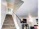 Staircase leading to upper level with carpeted steps and handrail at 4856 E Hinsdale Pl, Centennial, CO 80122
