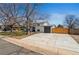 Spacious property with manicured lawn, long driveway, garage, and charming home, blending comfort and convenience at 9598 Lou Dr, Northglenn, CO 80260
