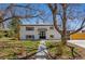 Classic home with brick, manicured lawn, mature trees, and inviting entryway, blending charm and curb appeal at 9598 Lou Dr, Northglenn, CO 80260