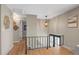 Bright and airy hallway with hardwood floors, modern lighting, and access to various rooms, creating a welcoming flow at 9598 Lou Dr, Northglenn, CO 80260