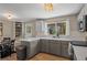 Well-lit kitchen with ample counter space, modern appliances, and a convenient breakfast bar for casual dining at 9598 Lou Dr, Northglenn, CO 80260