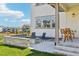 Relax on the back patio with a cozy fire pit, complemented by stylish chairs and outdoor seating at 6558 Kenzie Cir, Castle Pines, CO 80108