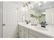 Bathroom featuring a double vanity with modern fixtures, quartz countertop, decorative mirrors and soft neutral color palette at 6558 Kenzie Cir, Castle Pines, CO 80108