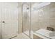 Modern bathroom features an enclosed glass shower with tiled walls and a built-in bench seating at 6558 Kenzie Cir, Castle Pines, CO 80108