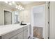 Stylish bathroom featuring gray cabinets, a black faucet, and decorative tile at 6558 Kenzie Cir, Castle Pines, CO 80108