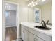A bathroom vanity offers a black sink, white counter, and cabinets for storage at 6558 Kenzie Cir, Castle Pines, CO 80108