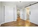 Hallway with hardwood floors, two closets, and a bathroom at 6558 Kenzie Cir, Castle Pines, CO 80108