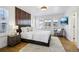 This bedroom includes a wooden accent wall, natural light and a seating area with chair and TV at 6558 Kenzie Cir, Castle Pines, CO 80108