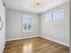 Bright bedroom with hardwood floors, large windows, and neutral paint at 6558 Kenzie Cir, Castle Pines, CO 80108