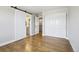 The sliding barn door is a feature of this bedroom with access to a bathroom and closet at 6558 Kenzie Cir, Castle Pines, CO 80108