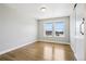 The bedroom provides natural light through its windows and hardwood floors offer a polished look at 6558 Kenzie Cir, Castle Pines, CO 80108