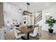 Charming dining space featuring modern lighting and a cozy ambiance that is perfect for entertaining and Gathering meals at 6558 Kenzie Cir, Castle Pines, CO 80108