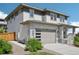 Modern home featuring stone accents, a two-car garage with a contemporary door, and low-maintenance landscaping at 6558 Kenzie Cir, Castle Pines, CO 80108