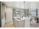 Open kitchen with stainless appliances, large island, and sliding glass doors to the backyard at 6558 Kenzie Cir, Castle Pines, CO 80108