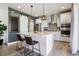 Beautiful kitchen features a large island with seating and stainless steel appliances at 6558 Kenzie Cir, Castle Pines, CO 80108