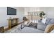 Modern living room featuring neutral paint, stylish decor, with comfortable gray sofa and area rug at 6558 Kenzie Cir, Castle Pines, CO 80108