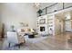 Bright living room with vaulted ceilings, a modern fireplace, and stylish decor, creating a welcoming space at 6558 Kenzie Cir, Castle Pines, CO 80108