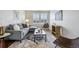 Bright living room with a gray sofa, modern area rug, and large window for natural light at 6558 Kenzie Cir, Castle Pines, CO 80108
