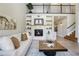 Elegant living room featuring a cozy fireplace, built-in shelving, and an open layout for comfortable living at 6558 Kenzie Cir, Castle Pines, CO 80108
