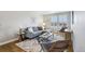 The living room features a gray sofa, wood chairs, and natural light from the windows at 6558 Kenzie Cir, Castle Pines, CO 80108