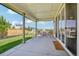 Covered patio with ample space for dining, seamlessly connecting indoor and outdoor living at 6558 Kenzie Cir, Castle Pines, CO 80108