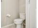 Clean half bathroom with white toilet and tiled floor at 6558 Kenzie Cir, Castle Pines, CO 80108