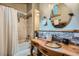 Bathroom featuring vanity sink, tiled shower and backsplash, and round mirror at 5739 Highway 9, Breckenridge, CO 80424