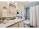 Cozy bathroom featuring a shower/tub combo, vanity with storage, and neutral tile throughout at 5739 Highway 9, Breckenridge, CO 80424