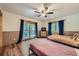 Bright bedroom with a private deck, two beds, ceiling fan, and wood accents at 5739 Highway 9, Breckenridge, CO 80424