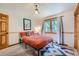 Cozy bedroom with a unique overhead light fixture and large window with a view of the trees at 5739 Highway 9, Breckenridge, CO 80424