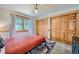 Bright bedroom featuring a large window, two closets, and neutral walls complemented by a colorful rug at 5739 Highway 9, Breckenridge, CO 80424