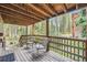 Relaxing deck with outdoor seating surrounded by lush greenery and views of the peaceful forest at 5739 Highway 9, Breckenridge, CO 80424
