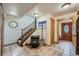 Inviting entry hall featuring tile flooring, staircase, coat rack, and wood accents at 5739 Highway 9, Breckenridge, CO 80424